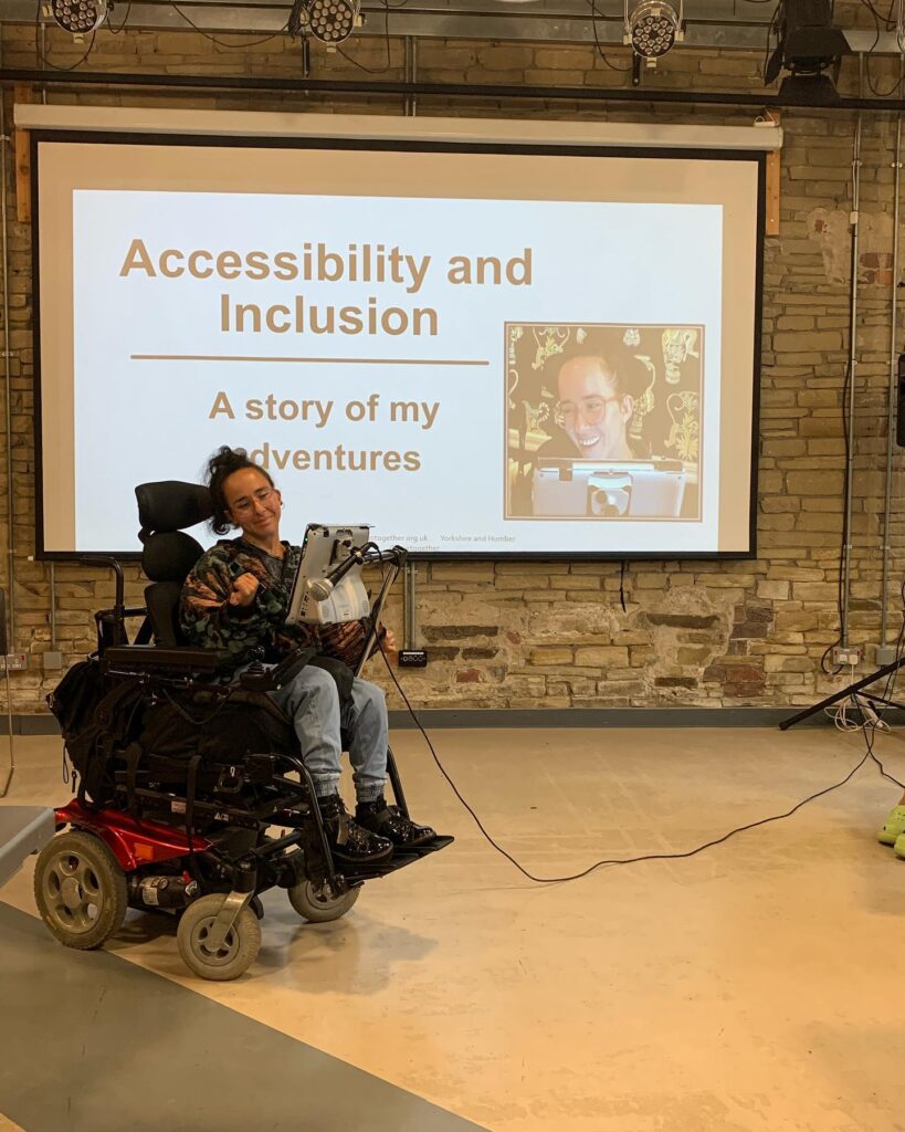 An Image of a person in a wheelchair delivering a session on Accessibility & Inclusion Training